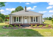 Charming single-story home with a welcoming front porch and beautifully landscaped flower beds at 233 Sellars Rd, Kings Mountain, NC 28086