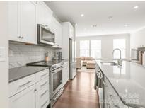 Bright kitchen featuring stainless steel appliances, white cabinets, and a stylish countertop at 3007 Citizens Ln, Charlotte, NC 28205