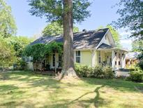 Charming single-story home with a welcoming front porch and a lush green lawn at 436 8Th Avenue Nw Dr, Hickory, NC 28601