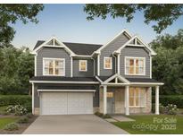Charming two-story home with gray siding, a two-car garage, and a well-manicured lawn at 726 Lithia Inn Rd, Lincolnton, NC 28092