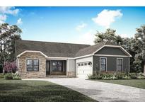 Charming one-story home showcasing stone accents, gray siding, a paved driveway, and a well-maintained front lawn at 1644 Dresden St, Rock Hill, SC 29732