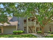 Charming condo exterior with mature trees and well-maintained landscaping at 2533 Stockbridge Dr, Charlotte, NC 28210