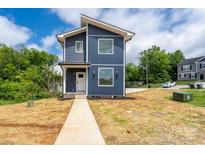 Modern two-story home with blue siding, white trim, and a well-maintained front yard at 304 Cabarrus W Ave, Concord, NC 28025
