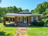 Charming brick home with a covered front porch, well-maintained lawn, and a welcoming entrance at 435 W Whitley St, Norwood, NC 28128