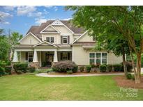 Charming traditional home with covered front porch, manicured lawn, and beautiful landscaping at 6873 Pine Moss Ln, Clover, SC 29710