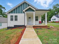 Charming bungalow with a welcoming front porch and freshly landscaped yard at 900 4Th St, Spencer, NC 28159
