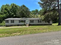 Charming single-story home with neutral siding, black shutters, and a well-maintained front yard at 9044 Forington Ln, Gastonia, NC 28056