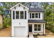 Charming two-story home with a white exterior, black shutters and a one-car garage at 105 Spring Garden Dr, Gastonia, NC 28052