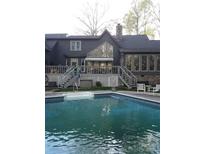 Relaxing backyard pool with stone trim and nice porch at 1115 John Short Rd, Indian Land, SC 29707