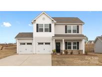 Charming two-story home with a two car garage, black shutters, and a well-manicured lawn at 124 Canada Dr # 45, Statesville, NC 28166
