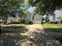 Charming two-story home with a well-manicured front yard and a two car garage at 2567 Holly Oak Ln, Gastonia, NC 28056