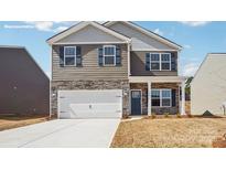Charming two-story home with stone accents, a two-car garage, and a well-maintained front yard at 2617 Goose Fair Rd, Maiden, NC 28650