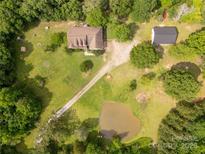 Expansive property featuring a house, outbuilding, pond, and lush surrounding greenery at 2818 Neill Rd, Lancaster, SC 29720