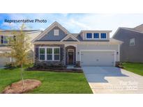 Charming single-Gathering home with a manicured lawn, stone accents, and an attached two-car garage at 3128 Spring Iris Dr, Denver, NC 28037