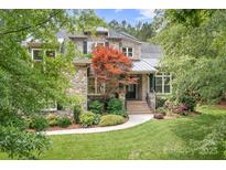 Beautiful stone home with mature landscaping, walkway and meticulous lawn at 3204 Mcpherson St, Waxhaw, NC 28173