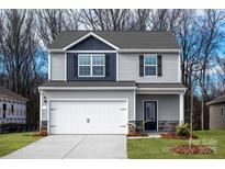 Charming two-story home features a two-car garage, stylish siding, and well-maintained landscaping at 3323 Burberry Dr, Gastonia, NC 28052