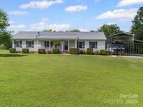 Charming single-story home with a well-manicured lawn and a covered carport for convenient parking at 714 Helms Efird Rd, Marshville, NC 28103