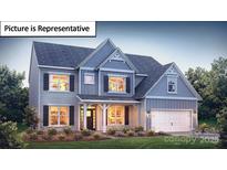 Charming two-story home showcasing gray siding, a covered porch, and an attached two-car garage at 7196 Sylvan Retreat Dr, Denver, NC 28037