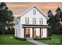Charming two-story white farmhouse-style home with inviting front porch and manicured lawn at 0000 Trull Hinson Rd # 2, Wingate, NC 28174