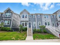 Charming townhouse with a well-maintained lawn, inviting entryway, and modern gray siding at 1015 Maltby St, Charlotte, NC 28217