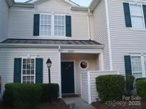 Charming townhome featuring stylish dark green shutters and a welcoming covered entrance at 11107 Lions Mane St, Charlotte, NC 28273
