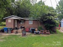Modest brick single story with mature trees in the front yard at 1210 Grady St, Salisbury, NC 28144