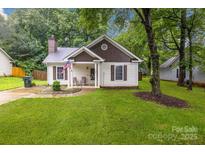 Charming one-story home with well-manicured lawn and cozy front porch at 124 Cedarcroft Dr, Mooresville, NC 28115