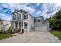 Charming two-story home with a welcoming front porch and a spacious two-car garage at 12719 Walking Stick Dr, Charlotte, NC 28278