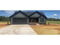 Charming single-story home with gray siding, black trim, and a concrete driveway at 1337 Hartsoe Rd, Lincolnton, NC 28092