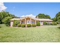 Charming brick home with a well-manicured lawn and mature landscaping at 2078 Valley View Ln, Lincolnton, NC 28092