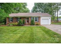 Charming brick home with a lush green lawn and a well-maintained landscape, offering great curb appeal at 2418 Live Oak Ct, Gastonia, NC 28056