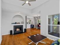 Bright living room features a fireplace, hardwood floors, and an open floor plan at 2625 E 5Th St # F, Charlotte, NC 28204