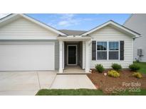 Charming home featuring a covered front door, neat landscaping, and an attached garage, creating inviting curb appeal at 2656 Goose Fair Rd # 126, Maiden, NC 28650
