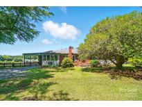 Charming single-story home featuring a brick chimney and well-maintained front lawn with mature trees at 2722 Catawba Church Rd, Rock Hill, SC 29730