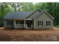 Charming single-story home with a covered porch and black shutters, nestled in a wooded area at 3452 Hands Mill Hwy, York, SC 29745