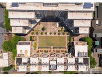 Unique aerial view of a community space nestled between buildings with green lawns and trees at 400 N Church St # 422, Charlotte, NC 28202