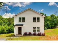 Charming two-story home with white siding, green trees, and a well-maintained front yard at 415 Kickapoo Ave, Gastonia, NC 28056