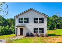 Charming two-story home with black shutters and landscaped front yard at 415 Kickapoo Ave, Gastonia, NC 28056