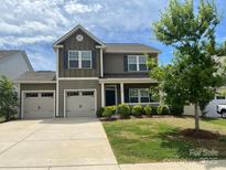 Charming two-story home with a well-manicured front yard and a three car garage, perfect for families at 5160 Thomasville Dr # 123, Belmont, NC 28012