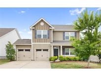 Charming two-story home with a two car garage, well-manicured lawn, and inviting front porch at 5160 Thomasville Dr # 123, Belmont, NC 28012