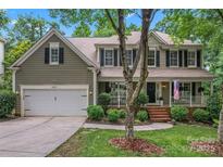 Charming two-story home with a covered front porch, two car garage, and well-manicured lawn at 5233 Fairvista Dr, Charlotte, NC 28269