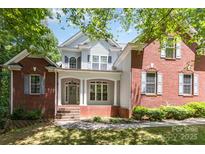 Charming two-story home featuring a classic mix of brick and siding with a welcoming front porch at 6655 Maple Spring Ct, Denver, NC 28037