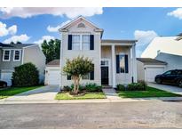 Charming two-story home with a well-manicured lawn and inviting curb appeal on a sunny day at 8605 Sawleaf Ct, Charlotte, NC 28215