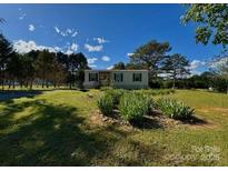 Charming single-story home with well-maintained lawn and front yard, perfect for outdoor enjoyment at 8827 Spring Meadow Dr, Hickory, NC 28601
