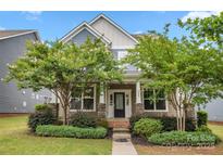 Charming home with a welcoming front porch, featuring stone accents and mature landscaping at 1020 Bannister Rd, Waxhaw, NC 28173