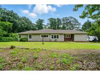 Charming single story home with a well-maintained lawn and mature trees at 1038 Blake Rd, Albemarle, NC 28001