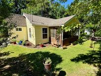 Charming home with screened-in porch, lush lawn, and beautiful landscaping in a serene, tree-filled setting at 105 Venus Ave, Gastonia, NC 28052