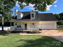 Charming two-story home with a welcoming front porch and attached two-car garage at 1505 Wimbleton Woods Dr # 5, Fort Mill, SC 29708