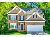 Charming two-story brick home with a well-maintained lawn and lush green trees, creating a welcoming curb appeal at 1648 Jonesberry Dr, Rock Hill, SC 29732