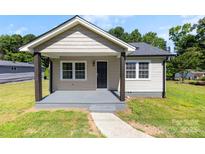 Charming single-story home with a covered front porch, neutral siding and walkway at 2009 Auten Rd, Gastonia, NC 28054